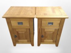 A pair of pine effect bedside cabinets,