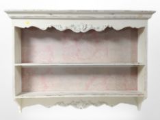 A French carved and cream painted wall shelf,