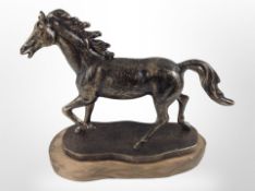 A cast-iron figure of a horse on wooden plinth, height 19cm.
