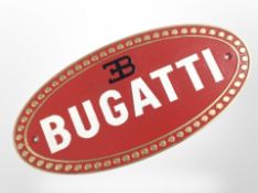 A cast-iron Bugatti plaque, width 35cm.