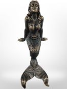 A cast-iron seated mermaid, height 24cm.