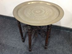 A bobbin turned folding occasional table with engraved brass top,