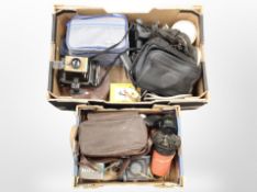 Two boxes containing vintage cameras including Polaroid camera accessories and bags,