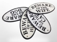 Four painted cast-iron plaques, 'Beware of the husband', 'Beware of the wife', etc., length 17cm.