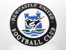 A cast-iron Newcastle United plaque, diameter 24cm.