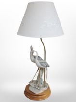 A Florence bisque porcelain table lamp modelled as two herons,