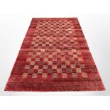 A machine-made carpet on red ground,