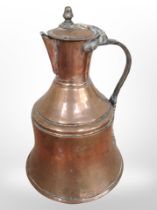 A 19th-century copper jug, height 31cm.