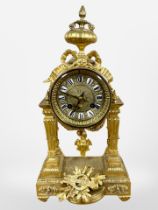 A 19th century French gilt metal portico eight day mantel clock, striking on a bell,