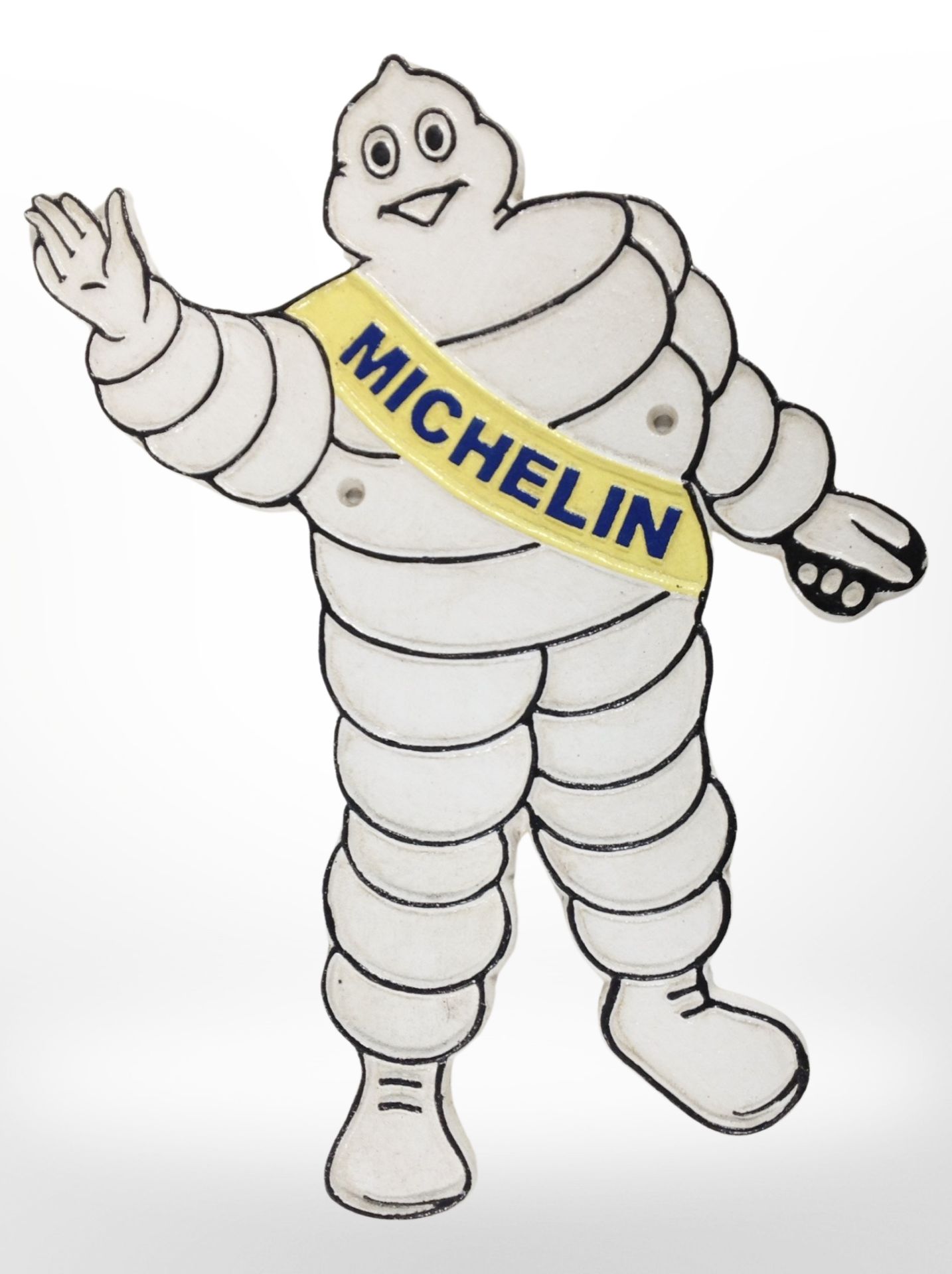 A cast-iron Michelin Man plaque, length 35cm.