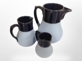 A graduated set of three pottery jugs, stamped 'Lovatt, Langley Mill, England', tallest 16.5cm.