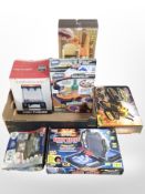 A box of toys and games including Shooting Gallery, all-terrain robot, strategy games, etc.