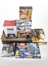 A box of toys and games including Shooting Gallery, all-terrain robot, strategy games, etc.