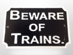 A cast-iron 'Beware of trains' plaque, width 30cm.