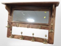 A brass and hardwood mirror back hat and coat rack,