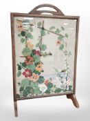 An early 20th-century oak tapestry fire screen, height 70cm.