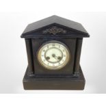 A Victorian black slate mantel clock with enamelled dial, height 28cm.