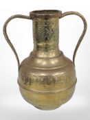 A decorative Indo-Persian hammered brass twin-handled vase, height 37cm.