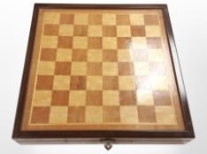A chessboard containing a set of Eastern resin chess pieces.
