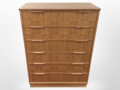 A Danish teak and pine six drawer chest,