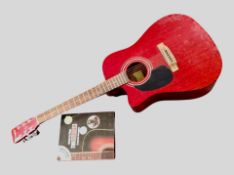A Westfield acoustic guitar and a guitar learning guide
