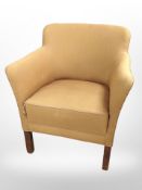 A 20th century armchair in mustard upholstery,