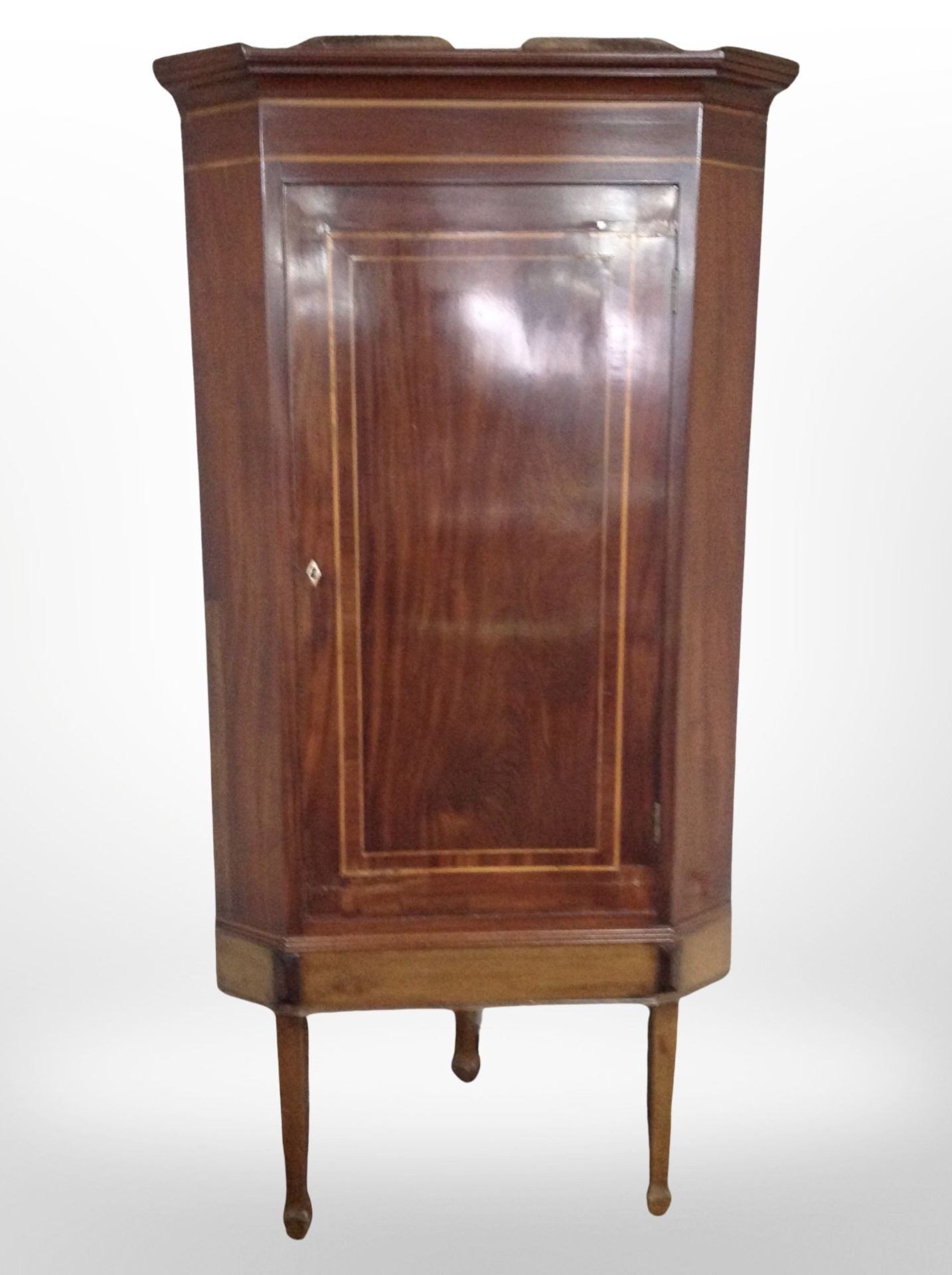 A George III mahogany and satin wood banded corner cabinet,