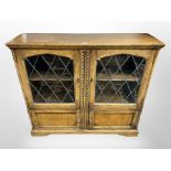 A reproduction glazed oak side cabinet,