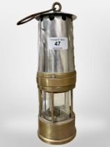 A brass and chrome miner's lamp.