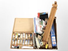A group of art supplies, including artist's box containing paints, sets of pencils, art books,