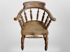 A 19th century beech spindle back captain's style chair,