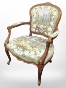 A French carved beech salon armchair in tapestry fabric,