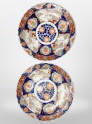 A pair of late 19th-century Japanese Imari porcelain chargers, diameter 37cm.