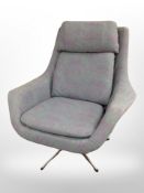 A Scandinavian swivel armchair on chrome support, in floral fabric,