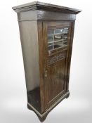 An early 20th century continental oak single door cabinet,