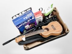 A box of musical items including Freshman ukulele in carry bag, music stands, microphone,