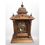 A Victorian walnut bracket clock, with brass dial striking on a gong,