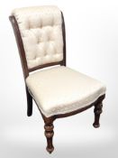 A Victorian style salon chair in buttoned upholstery