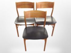 A set of six Danish teak and black vinyl dining chairs