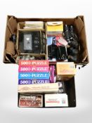 Two boxes containing binoculars, mobile phones, cameras, puzzles and games.