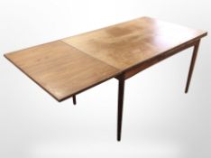A 20th century Danish teak pull-out extending dining table,