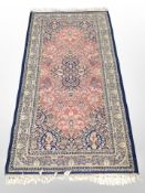 A machine made Persian style rug,