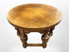 An oak circular coffee table on turned bulbous supports,