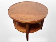 A reproduction mahogany circular coffee table,