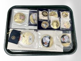 A group of gold-plated royal commemorative coins.