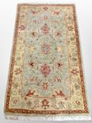 A Persian style rug on green ground 163 cm x 90 cm