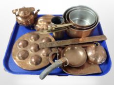 A group of kitchenalia including three graduated sauce pans, copper moulds, teapot, funnel, etc.