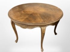 A continental carved beech circular occasional table on cabriole legs,