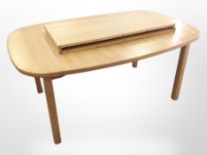 A Danish blond oak extending table, with two leaves,