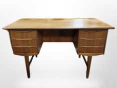 A Danish teak writing desk, fitted with six drawers,